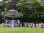 Community Choir on the bandstand and the Choral Society waiting